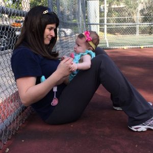 mom-with-baby-tennis-court